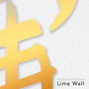 Close up on a kanji design made with gold ink on a limewall background